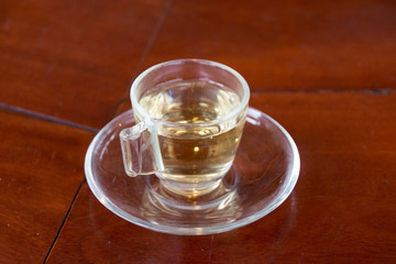 Close up hot tea herb in cup on table