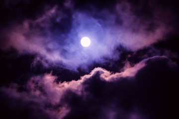 Naklejka na ściany i meble The moon on the dark sky among the clouds, natural abstract background