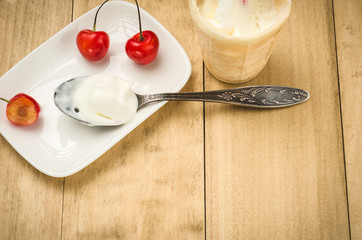 cherries on a white saucer and ice cream/cherries on a white saucer and ice cream with copy space