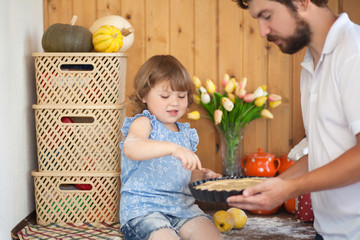 Father baking cake with his cute little daughter