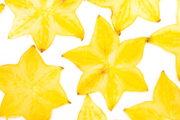 Naklejka premium Star fruit on white isolated background translucent delicious natural sweet shape starfruit food texture detail macro close up carambola graphic pattern