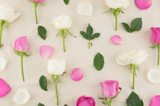 Pink, white roses, petals and green leaves pattern on white muslin fabric