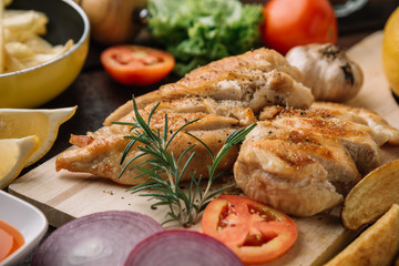 Close up Roast chicken breast sliced on choppingboard with ingredient.