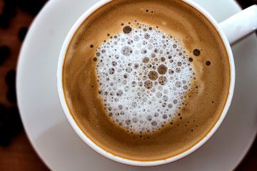Coffee in white cup on table