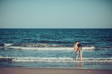 Young couple in love walking on the beach