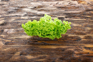 Fresh lettuce on wooden surface. Space for text. top view