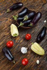 Vegetables on vintage wood background - summer harvest, soup ingredients. Rural still life from above. Tomato, eggplant, garlic, pepper.top view