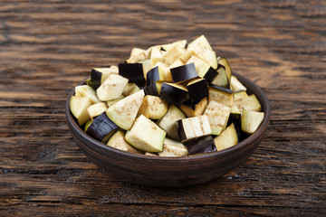 Freshly sliced eggplant in a clay bowl. Space for text