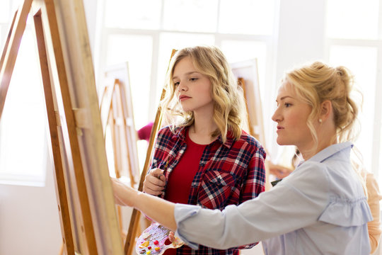 student and teacher with easel at art school