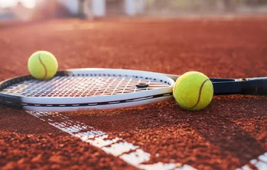 Deurstickers Tennis ball with racket on the tennis court. Sport, recreation concept © bobex73