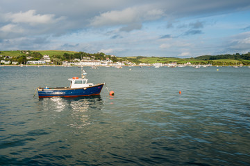 Fototapeta na wymiar Blue fishing motor boat moored in estuary at Appledore, Devon