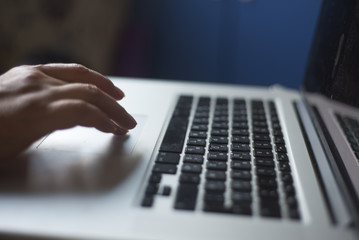 Woman programmer hacker hands type text on laptop keyboard with russian letters in a dark room close up selective focus photo