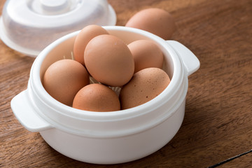 Raw Eggs on wooden table.