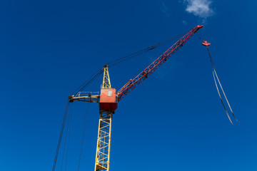 Old construction crane above blue sky