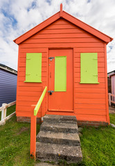 Colorful beach side huts on Devon coast of England