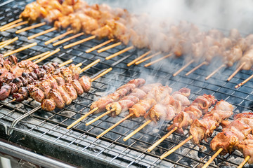 Grilling marinated meat on a charcoal grill