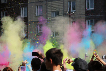 People throw dry colored paint in the air at the festival Holi festival in Gatchina, Russia.
