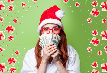 women in christmas hat with money