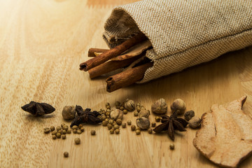 Star anise, cinnamon stick with spices and dried ginger in sack