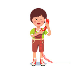 Kid boy talking on a retro wired telephone
