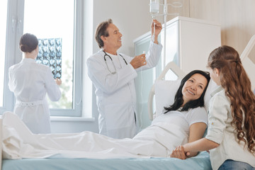 Fototapeta premium Nice joyful woman lying on the hospital bed