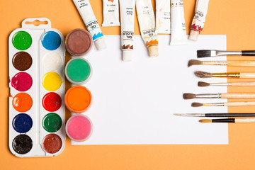 Paints brushes pencils paper colors mock up