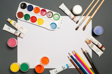 Paints brushes pencils paper colors mock up