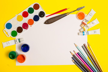 Paints brushes pencils paper colors mock up