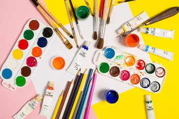 Paints brushes pencils paper colors mock up