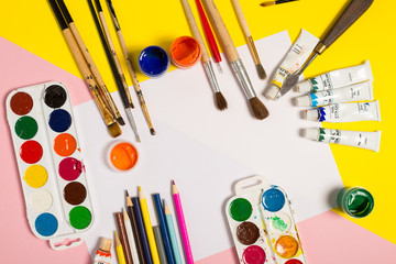 Paints brushes pencils paper colors mock up
