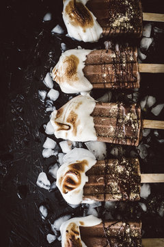 Row of smores popsicles on ice
