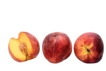 Peaches whole and sliced halves with a bone isolated on white background