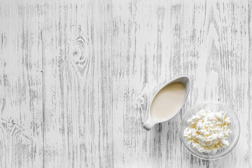 Farm dairy products. Milk and cottage on light wooden background top view copyspace