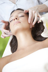 Obraz na płótnie Canvas Spa salon: Young Beautiful Woman Having Facial Massage