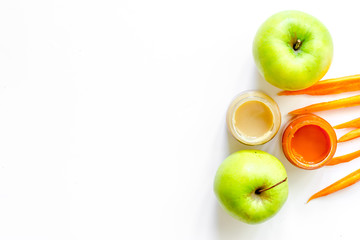 Preparing baby food. Pumpkin and apple puree on white background top view