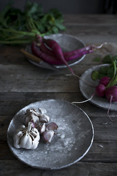 Fresh garlic on a plate in a vintage kitchen