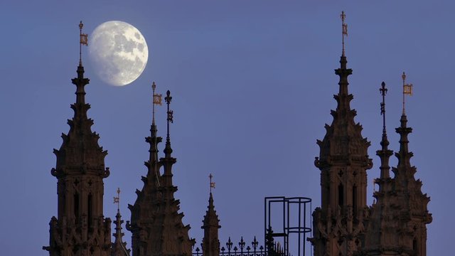 Palace Of Westminster With A Moon And Birds Flying Around It