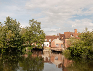 Fototapeta na wymiar a river cottage scene in summer light in flatford mill near dedham in constable country