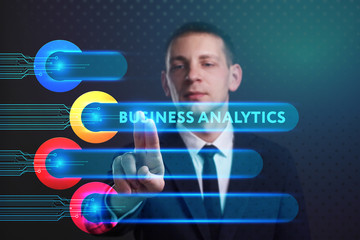 Business, Technology, Internet and network concept. Young businessman working on a virtual screen of the future and sees the inscription: Business analytics