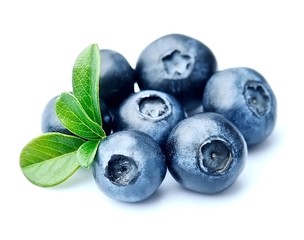 Blueberries with leaves close up .