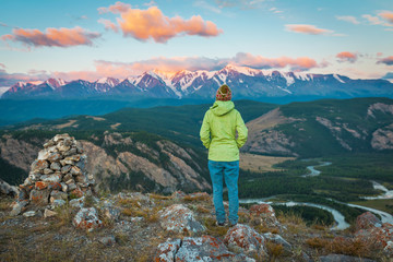 Beautiful girl on top of mountain watching sunrise