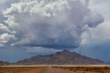 Fototapeta na wymiar Namibia gravel road C27 storm cloud