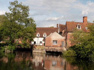 Fototapeta na wymiar beautiful old historic buildings mill in england reflected in running river
