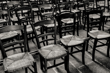 chairs in a church in black and white