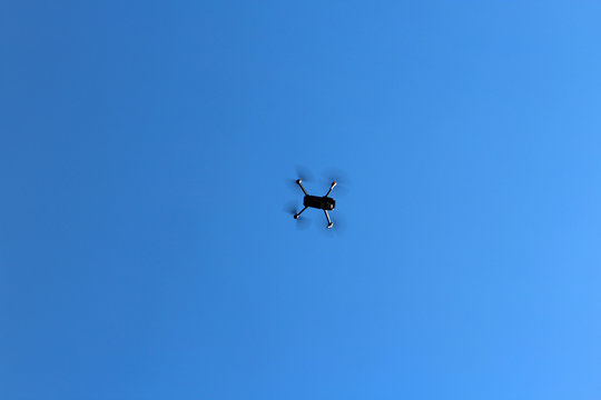 DJI Mavic Drone Flying in the Blue Sky Isolated Background