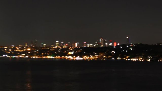 Spectacular view of Istanbul's bridge and coastline at night from a boat