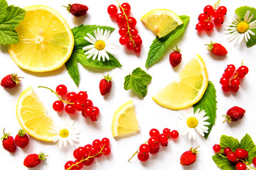 Fruit berry pattern from a strawberry strawberry red currant leaves mint and lemon against a light background to copy space