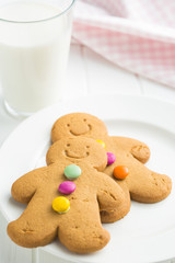 Sweet gingerbread men and glass of milk.