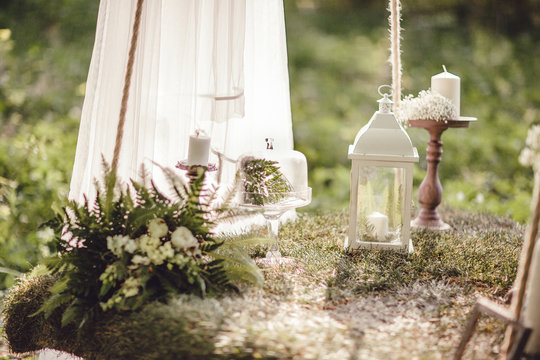 Wedding decor with flowers and candles in the forest