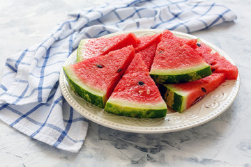 Slices of juicy watermelon on a ceramic dish.